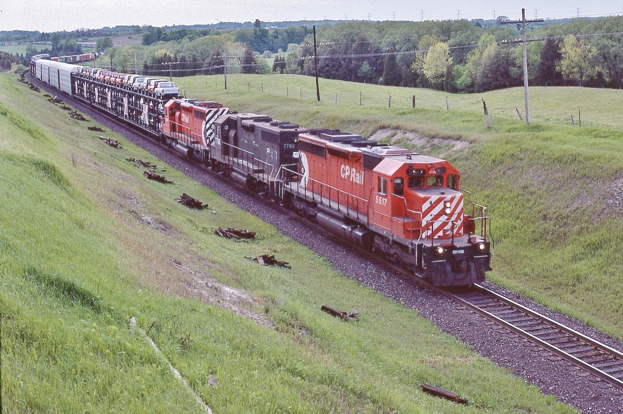 Open and closed tri level auto racks, single level containers.....


 and looking like an early #904,


With Conrail GP38 CR #7786 assisting CP Rail SD-40's #5517 & #5501,


at the CP Rail bee bridge, Nichols Road, May 25, 1985 Kodachrome by S.Danko


Those open tri levels loaded with 1985 Ford Ranger pickups and  Broncos on the top & 85 LTD's middle & 85 Mustangs on the bottom.


   The B Bridge  


sdfourty