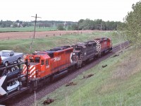 
<br>
<br>
Open tri levels loaded with 1985 Ford Ranger pickups and  Broncos & '85 LTD's middle & on the lower level '85 Mustangs.
<br>
<br>
CP Rail SD-40's #5517 / Conrail GP38 #7786  /  CP Rail  #5501,
<br>
<br>
at the CP Rail bee bridge, Nichols Road, May 25, 1985 Kodachrome by S.Danko
<br>
<br>
