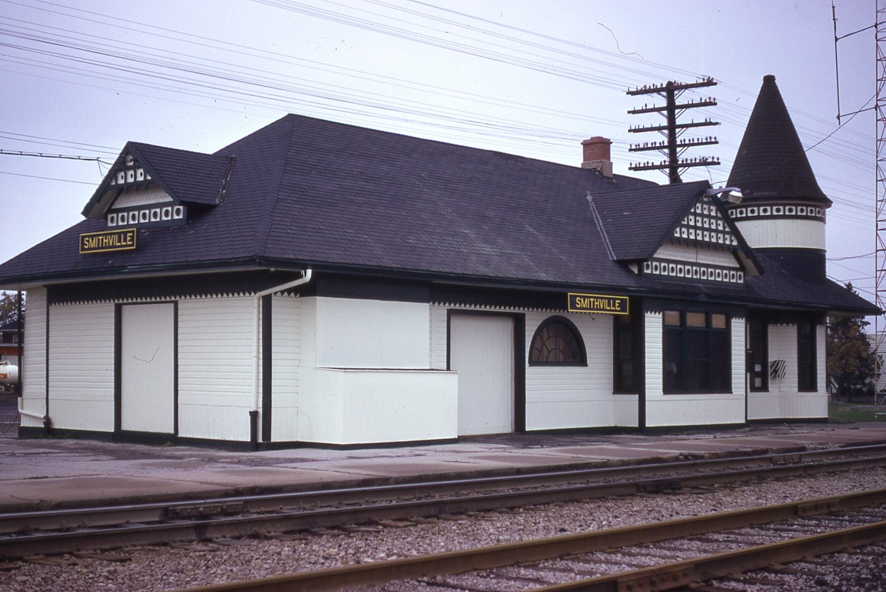 Smithville, situated about one third of the way from Hamilton toward Fort Erie for you out of province viewers, had one of the most beautiful, whimsical stations in Ontario. The structure was built in 1903, replacing an earlier station that burned. This image shows what must be the last gorgeous paint job before the station was abandoned after CP discontinued the Budd car passenger service in the spring of 1981. It sat empty until 1990. West Lincoln County purchased the building and at great expense had the station moved back from the railroad onto a good basement foundation. Later on, the West Lincoln Historical Society bought the station and lot from the Township of West Lincoln, and with the generosity of members and volunteers have kept the building in tip-top condition.