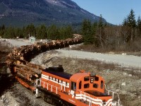 Crown Zellerbach 8427, an MLW RS-3 ex Canadian Pacific 8427 (and chop-nosed by CP), could easily win an ugly locomotive contest when viewed from its short hood end, but when sparkling clean and viewed from above, it was okay.  When photographed (from up a tree) departing with log loads from the dryland sort yard at Nanaimo Lakes on Thursday 1981-03-12 and heading to Ladysmith, it looked very recently painted.

<p>Today, that locomotive is in the care of the Western Vancouver Island Industrial Heritage Society in Port Alberni.
