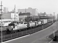 Along Front Street in New Westminster on Monday 1988-10-17 at 0915 PDT, a trio of GP35s, CP 5024 + 5009 + 5025, is arriving from Coquitlam yard in Port Coquitlam with a block of empty automobile racks on the headend for Annacis Island loading via interchange to Southern British Columbia Railway (just acquired 1988-10-01 by Itel Corporation from BC Hydro).

<p>CP 5009 is in the middle of the consist since the two GP30s and early GP35s on CP were not equipped with Reset Sensing Control equipment instead of a deadman pedal, but 5011 up to 5025 were fully equipped for lead service.