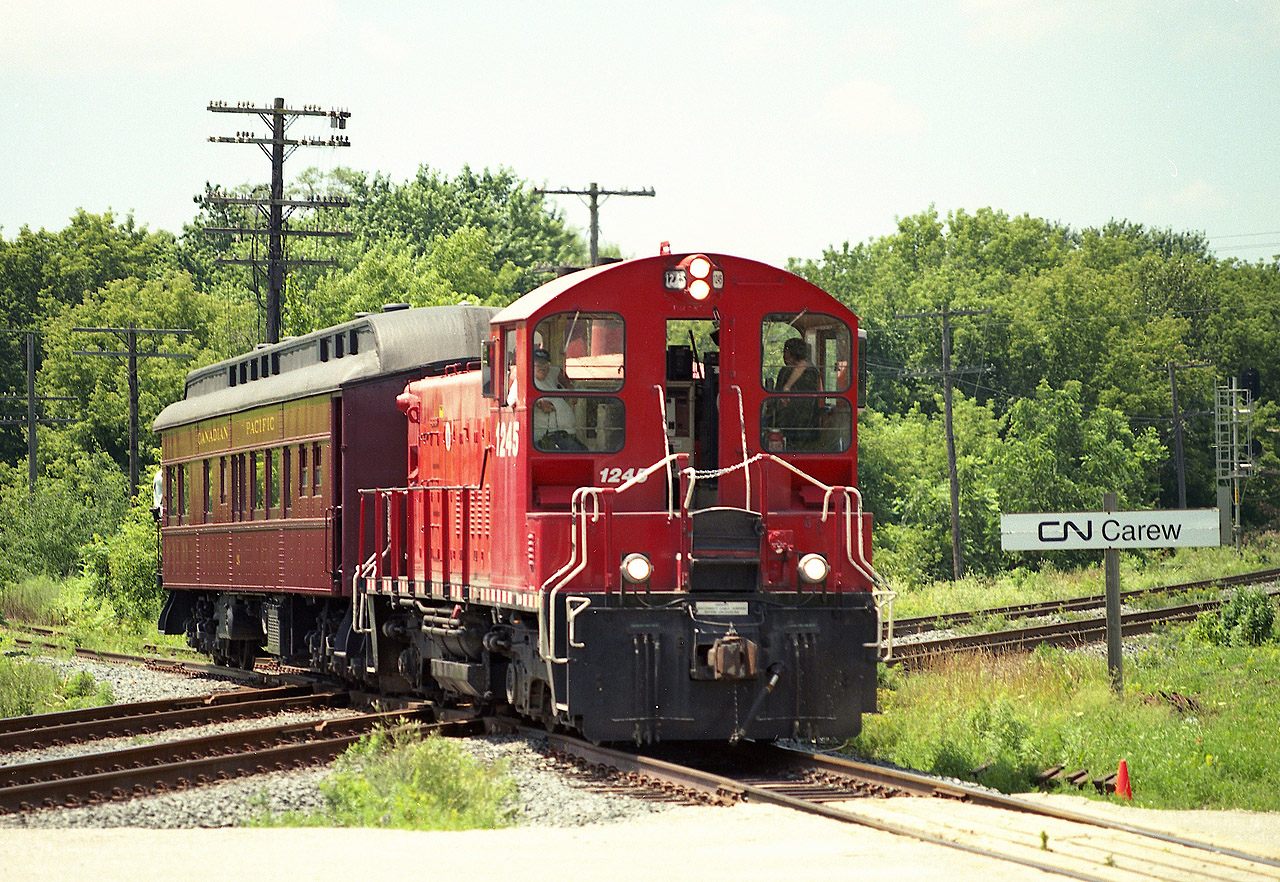 Seen here rolling over the CN Carew diamond, an OSR special family outing train is on the way to their connector with CP. They will stop by the old CP station there in Woodstock. The OSR 1245 will run around the passenger coach and they will head back to Salford.  What a way to spend a nice warm Sunday afternoon.