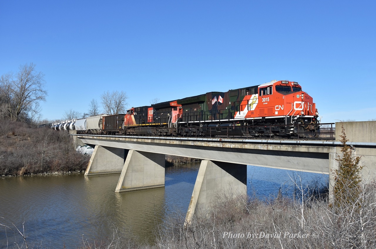 CN 3015 in Support Our Troops camo paint scheme and 3217 with a CN100 logo lead 562 out of Port Robinson and over the Welland River. The train will stop to set-off at Southern Yard before looping around onto the CP Hamilton Sub at Brookfield and passing beneath the Welland Canal to interchange with Gio Rail at Feeder. After lifting interchange from Gio will return via reverse route to Port Rob and attend to any other switching required in the area.