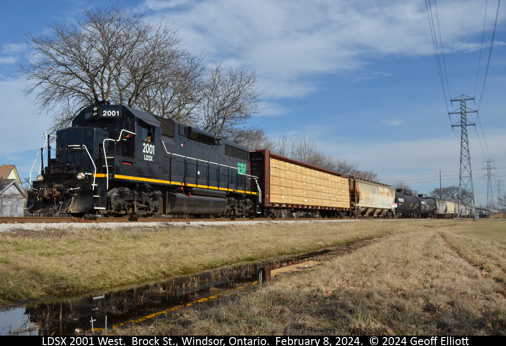 "Reflecting on 2001"......  Not the year, but LDSX GP38 #2001.  As the 0830 job continues west through Windsor it has just crossed Brock Street and rounds the bend on it's trip to Ojibway yard on February 8, 2024.  Rumors have it that LDSX 2001 has been purchased, but not by the Essex Terminal, so getting shots of this former C&O GP38 running on the ETR may be short lived.