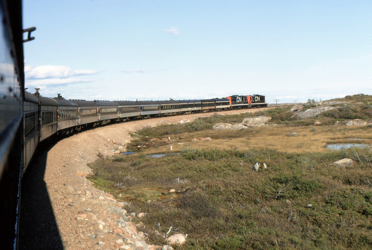 POND CROSSING PHOTO PERFECTION - While travelling with four University of Toronto friends - including the late, great, James A. Brown - to celebrate Canada's Centennial, John Freyseng of Ontario boarded Newfoundland's endangered passenger train 'Caribou' and was able to capture some amazing narrow gauge images. During his 22-hour, 547 mile journey to the provincial capital of St. John's he photographs CN Train No. 102, the eastbound Caribou with leading unit NF210 919 continuing to climb the infamous Gaff Topsails just past Pond Crossing on one of the longest days of the year. With arrival at Gaff Topsail scheduled for 18:40 and a little over a mile or so away, many have already finished up a delicious meal in Diner 173 and according to John, will spend several delightful hours being entertained in Diner/Café Car 172 at the head end. I chose this particular image moments after speaking with him today while a fierce Nor'easter is pounding the Avalon Peninsula, quite the contrast to the warm summer's evening as seem in this image. More of his breathtaking images can be seen in my latest, TRAINS OF NEWFOUNDLAND, hard and softcover editions by Flanker Press.