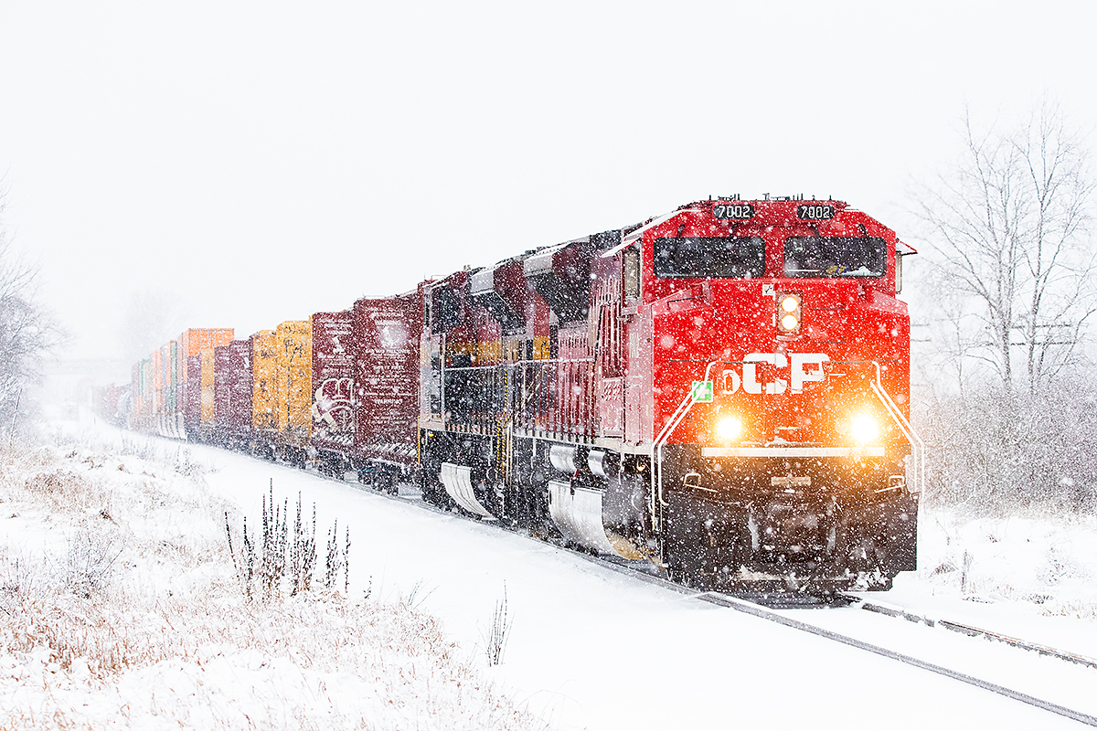 CP 7002 heads towards Smiths Falls and into one of only a few 2024 snowstorms so far.