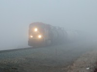 Appearing out of the fog CP 8787 approaches Range Road 222 while making it's way west on the Scotford Sub.