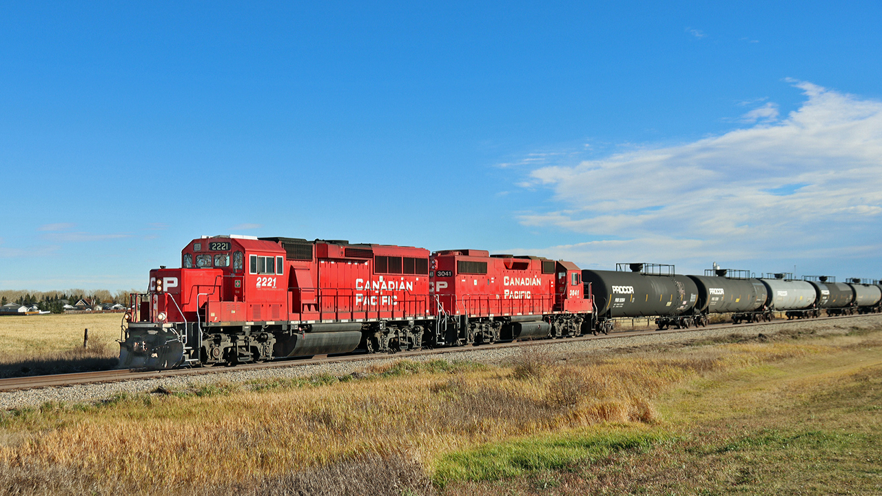 GP20C-ECO, CP 2221 and GP38-2, CP 3041 head north on the CPKC Red Deer Sub with a local cut of tank cars for the Didsbury Terminal.