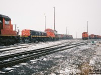 During early winter snow squalls, many locomotives are seen awaiting their next assignments on the CN MacMillan Yard diesel facility departure/ ready tracks in Vaughan, Ontario. Some of the units included SD40 5187 and GP9RM 7272 with GP9 Slug 272. On July 7, 1993 both 7272 and 272 were released from remanufacturing at the AMF facility (former CN Pointe-Saint-Charles shops) in Montreal, Quebec. They were rebuilt from former CN GP9’s 4208 and 4212. 