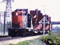  Don't recall what day it was, as notes are lost, but I do remember it being really hot and steamy. But then, it is July. CN 4592 is seen running westbound to Aldershot with some sort of special move. I miss those old wooden "Junction" signs...the one in this case referring to Burlington  and the Halton-Oakville Jct. QEW overpass in background.