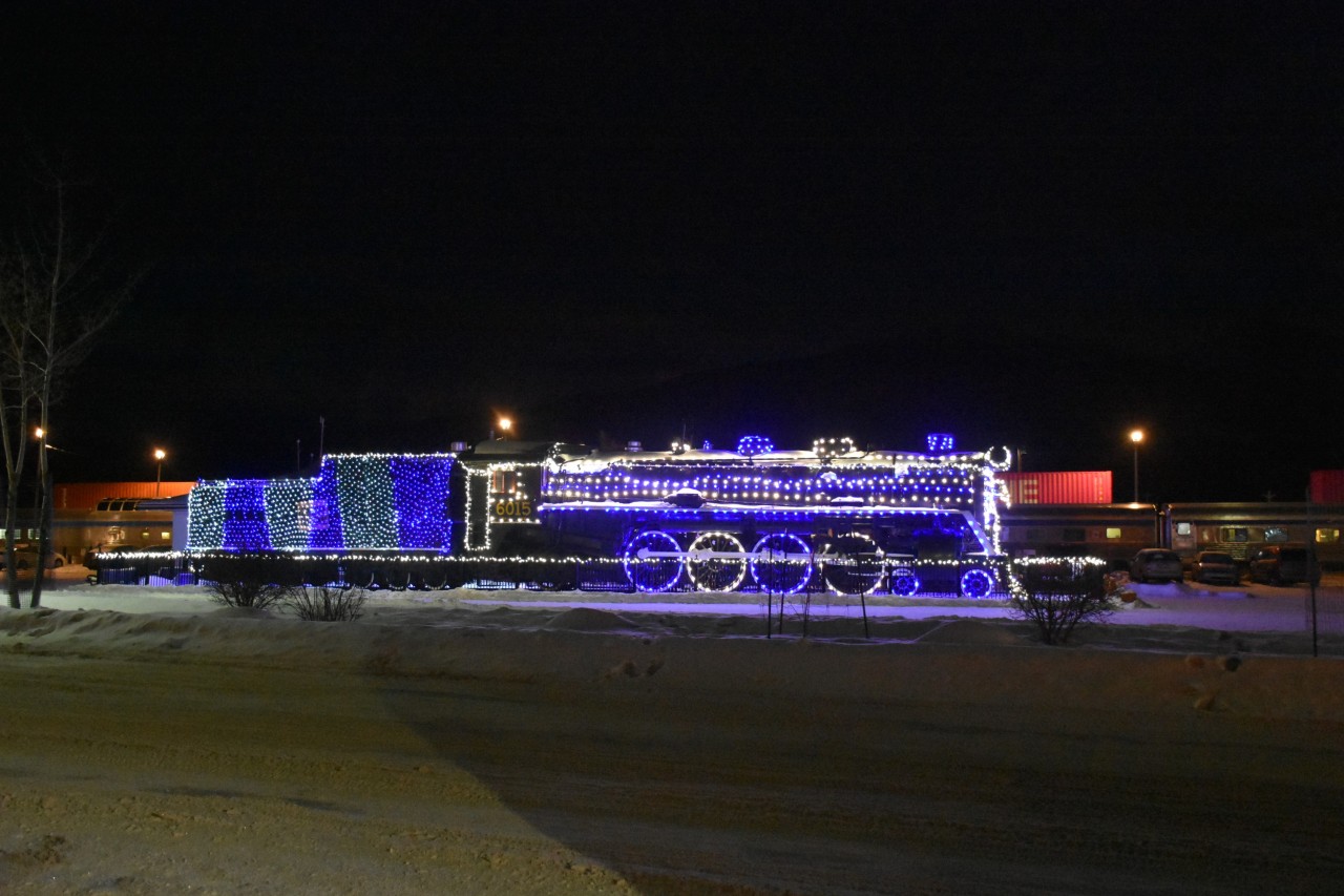Steam, Stainless, and Stacks 
Steam locomotive CN 6015 sits on static display while the stainless steel Budd built passenger cars of VIA Rail's No. 1 The Canadian sit on the station track next to a CN stack train waiting in the background for a fresh crew.
All this and more at 07:44 on a cold and crisp January 24, 2024 morning in Jasper, AB.