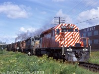 CP Rail SD40-2 5604 leads SD40 5544, RS18 8735, and a 4220-series C424 on a southbound freight past the Ontario Northland shops near Main Street overpass in North Bay. The paint on CP 5604 is still looking fresh and shiny, having been outshopped from GMD London months before in May 1972. SD40 5544 in old script paint wouldn't be long for the paint shop (sister 5541 would become the last SD40 in script, finally being repainted in mid-1975).<br><br>If one looks close enough, the first car behind the power is an old 40' stock car, usually handled at the head-end to make switching it out for feeding and watering the livestock inside easier.<br><br><i>Original photographer unknown, Dan Dell'Unto collection slide.</i>