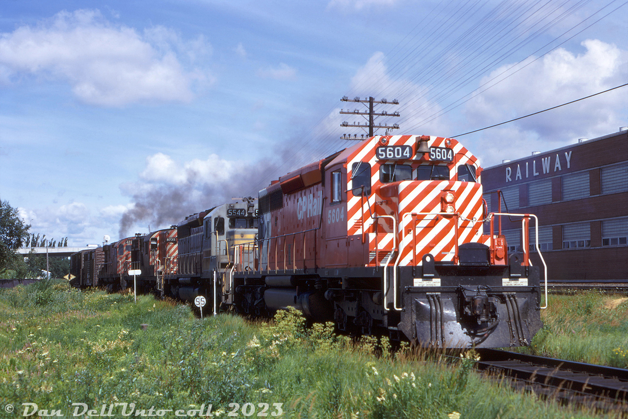 CP Rail SD40-2 5604 leads SD40 5544, RS18 8735, and a 4220-series C424 on a southbound freight past the Ontario Northland shops near Main Street overpass in North Bay. The paint on CP 5604 is still looking fresh and shiny, having been outshopped from GMD London months before in May 1972. SD40 5544 in old script paint wouldn't be long for the paint shop (sister 5541 would become the last SD40 in script, finally being repainted in mid-1975).

If one looks close enough, the first car behind the power is an old 40' livestock car, usually handled at the head-end to make switching it out for feeding and watering the livestock easier.

Original photographer unknown, Dan Dell'Unto collection slide.