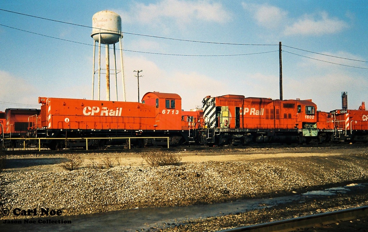 During an early winter morning, CP Rail Slug 6713 is viewed with GP9u 1602 at Toronto Yard’s diesel shop. In May 1993, SW900 6713 was converted into a Slug at CP’s St. Luc shop in Montreal, Quebec, prior to being assigned to Toronto. It was later renumbered to CP 1015 in 1996.