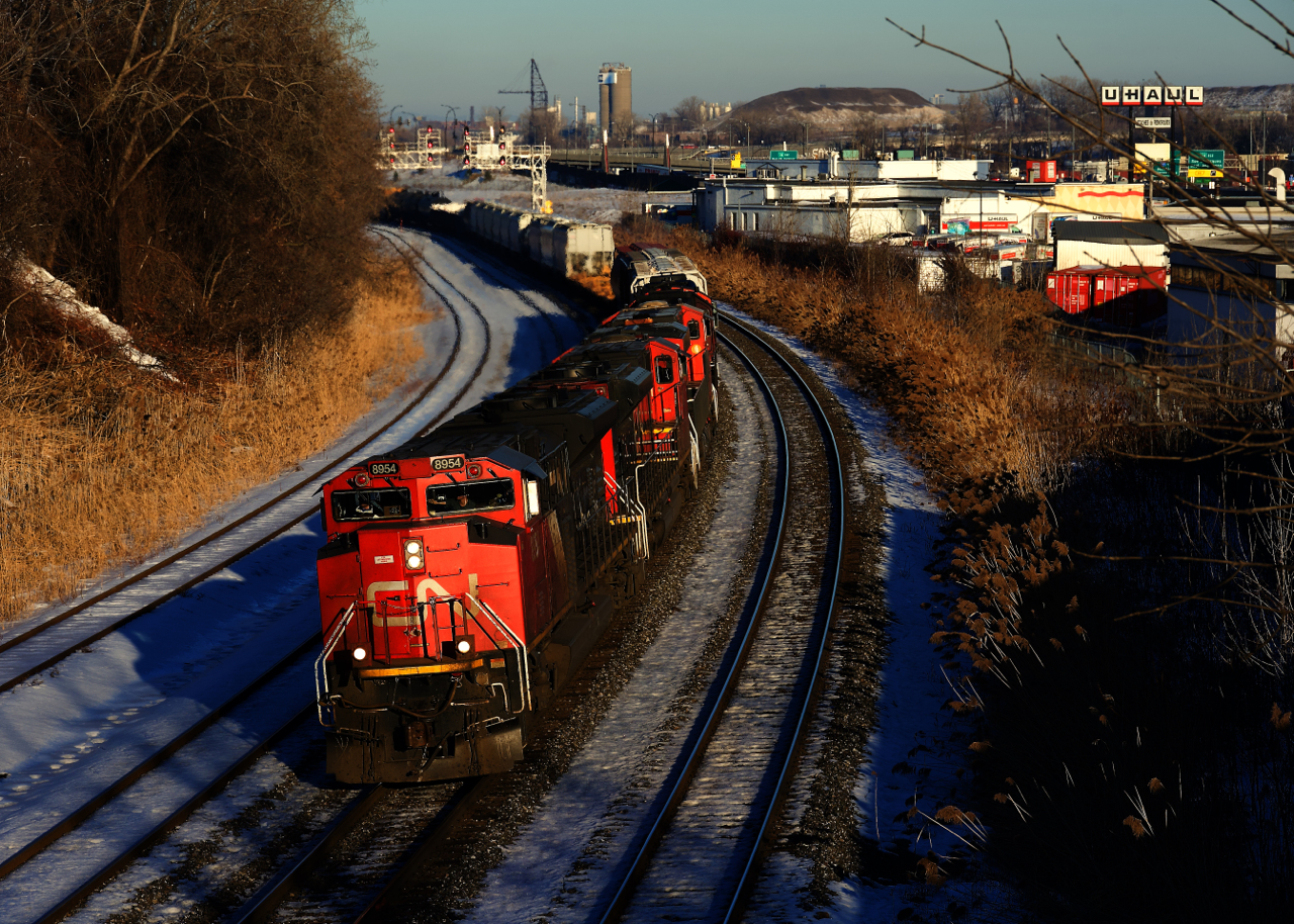 On the first full day of sun that Montreal has seen in quite some time, CN 527 heads west with CN 8954 leading four more units and a short train.