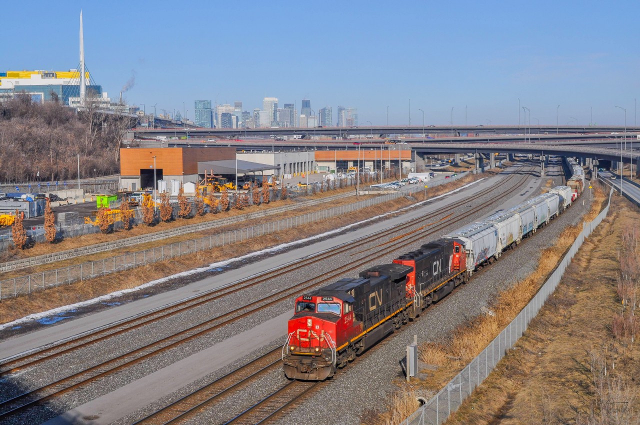 On February 13, 2024, CN 527 passes gently under the Turcot interchange, en route to Taschereau
