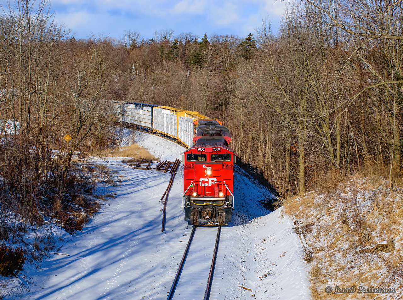Finding a break in the clouds, CPKC 238 is seen passing Waterdown on approach to Hamilton.