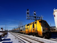 Two crewmembers wave as VIA 60 departs Dorval Station with VIA 918 and four HEP cars. Stainless steel consists such as this one no longer pass through here.