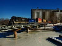 CN 500 has stacks up front as it crosses the icey Lachine Canal with IC 9628 & CN 4812 for power.
