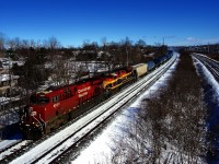 Ethanol empties are heading back west as CPKC 529 rounds a curve a bit past Beaconsfield Station with CP 8922 & KCSM 4094 for power.
