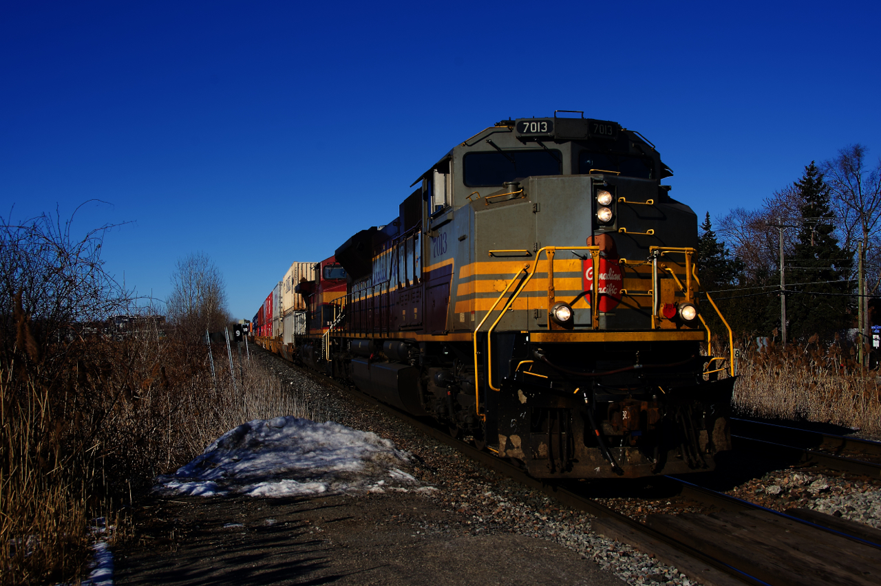 CP 2-112 is approaching Pine Beach Station with heritage unit CP 7013 and KCS 4612 up front on a cold and clear morning.