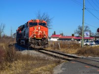 An entry for the time machine challenge with Bruce Acheson's 1990's shot <a href=https://www.railpictures.ca/?attachment_id=47962>as seen here.</a><br><br>CN L502 swings around the curve off the old Hagersville Sub alignment at Garnet, headed for a meet with Southern Ontario Railway 591 in Garnet Yard to swap traffic for Nanticoke industries.  An automotive business still uses the neighbouring property, with RPM Used Vehicles having become Smout's Garage.