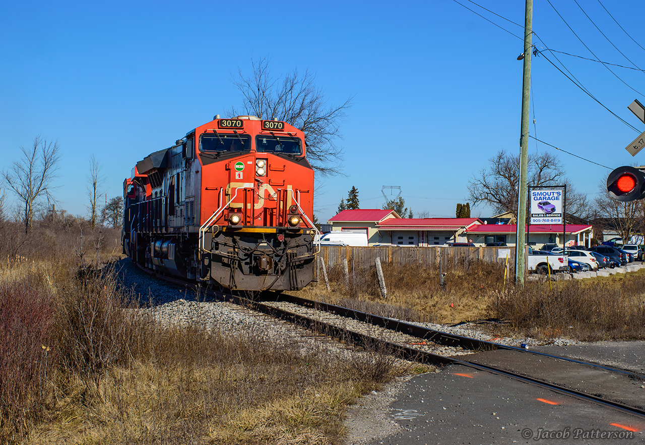 An entry for the time machine challenge with Bruce Acheson's 1990's shot as seen here.CN L502 swings around the curve off the old Hagersville Sub alignment at Garnet, headed for a meet with Southern Ontario Railway 591 in Garnet Yard to swap traffic for Nanticoke industries.  An automotive business still uses the neighbouring property, with RPM Used Vehicles having become Smout's Garage.