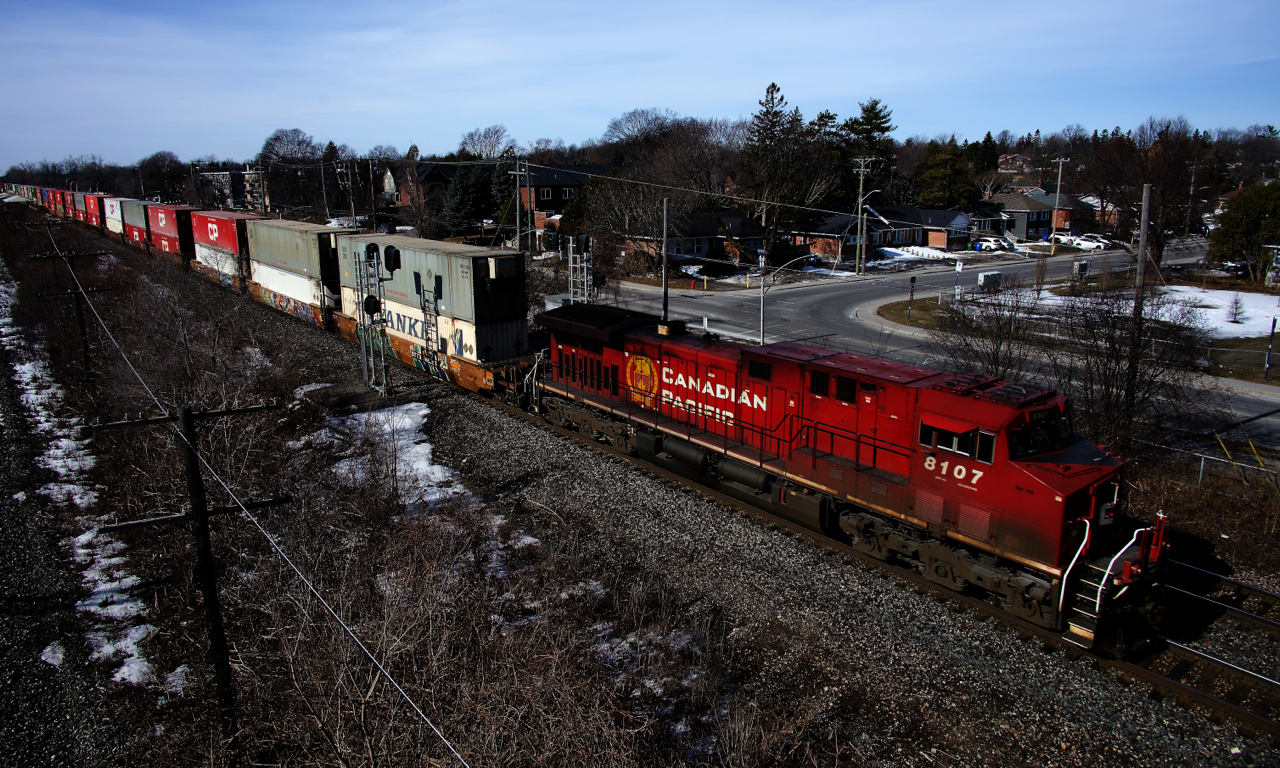 A CPKC 112 with 442 axles passes through Pointe-Claire with CP 8107 up front.