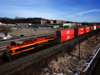 A CPKC 112 with 442 axles passes through Pointe-Claire with KCS 4841 bringing up the rear.