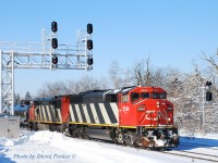  The view from atop "El Capitan' (A huge snowpile at the Westend of the GO parking lot) as an Eastbound led by CN 5544-CN 2428 passes through Georgetown on Feb 7th 2014. The trees in the background show the damage from the December 23rd Ice Storm that hit Southern Ontario. 