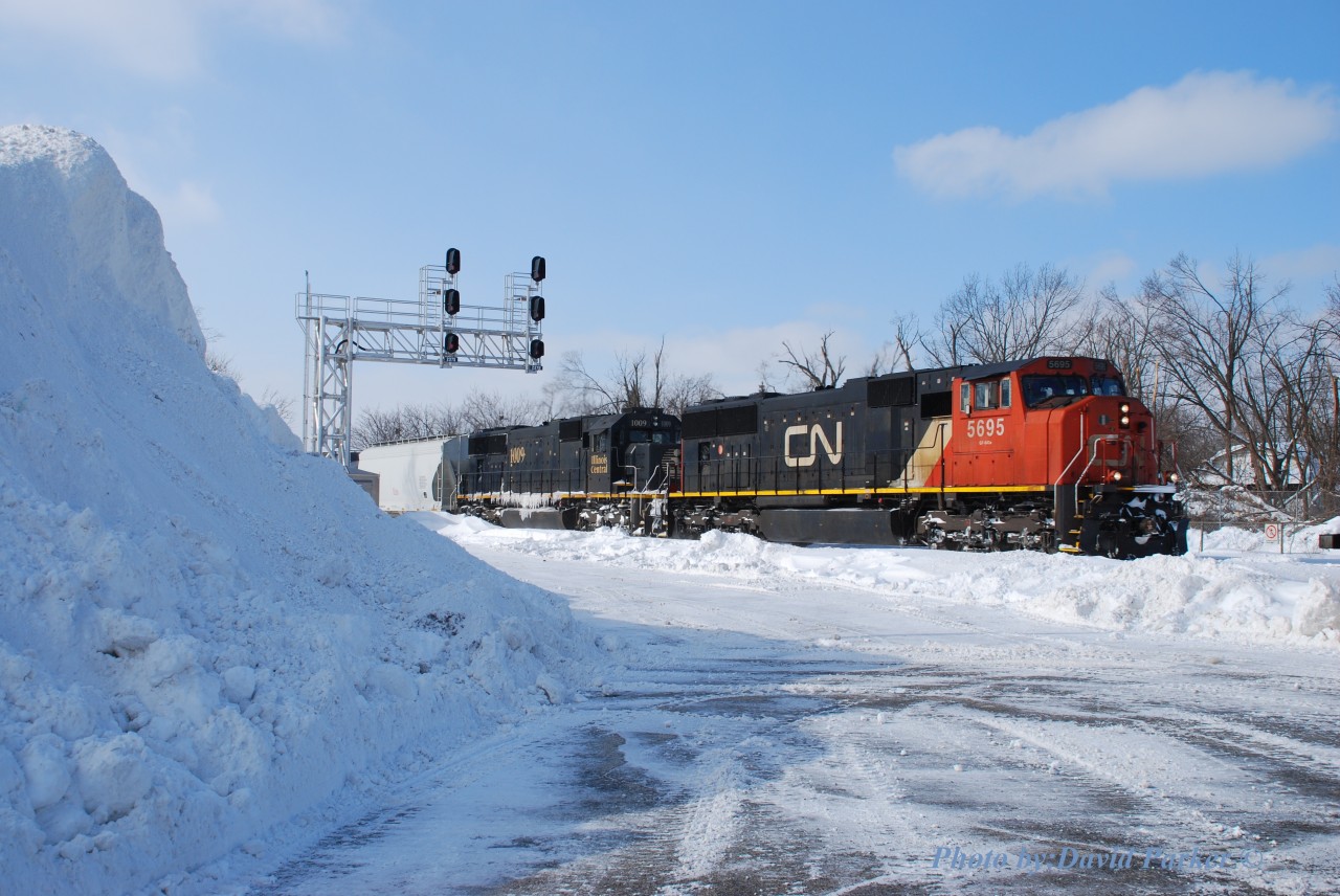 Lots of snow during the winter of 13-14 as evidenced by the giant pile at the West end of the GO parking lot at Georgetown. Nicknamed "El Capitan' by the locals, it provided some nice elevation for those brave enough to ascend it due to its steepness. Here we see an Eastbound passing by the sheer drop-off led by CN 5695-IC 1009 on Feb 7th 2014.