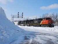  Lots of snow during the winter of 13-14 as evidenced by the giant pile at the West end of the GO parking lot at Georgetown. Nicknamed "El Capitan' by the locals, it provided some nice elevation for those brave enough to ascend it due to its steepness. Here we see an Eastbound passing by the sheer drop-off led by CN 5695-IC 1009 on Feb 7th 2014. 