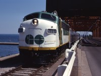 What is it that Monty Python used to say..."And now for something completely different". Well, you can say that again--a GO train on the Beach sub! This trip was sponsored by the Electric Railroader's Association on July 6, 1974 during the ERA's annual convention. The day started out with a TTC subway train charter then, after lunch, ran an excursion using new GO GP40-2LW 9810 and ACPU 9861 (ex ONT FP7 1512) and three single level coaches. The train ran northwest to Georgetown, down to Hamilton, over to Stoney Creek and across the Beach sub, before returning to Toronto over the Oakville sub. Here the train is shown at the Burlington Canal lift bridge at mile 4.8. (Caption information from the July-August 1974 UCRS Newsletter.)