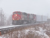 A southbound mixed freight waits in the siding during a squall.