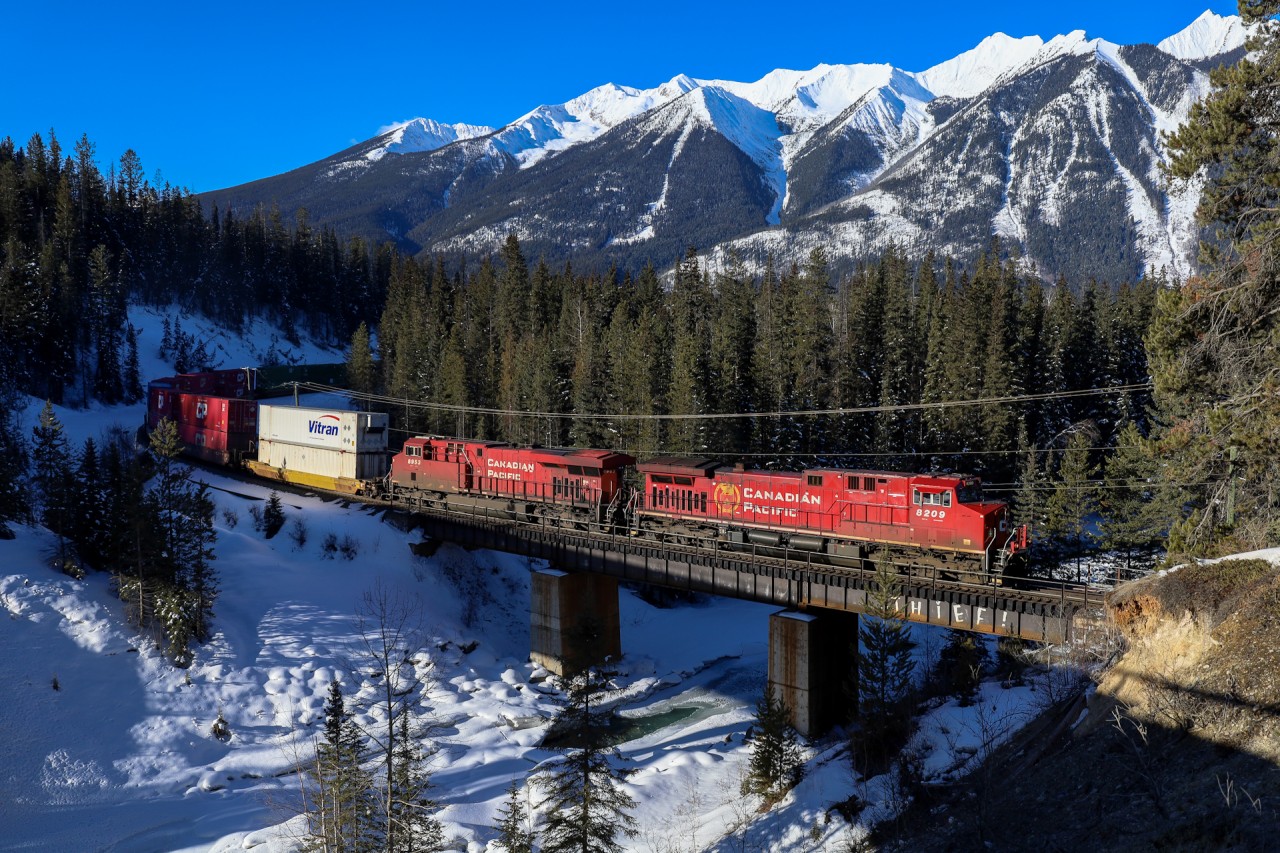 CPKC 2-112 climbs upgrade out of Ottertail.  With only 6 miles remaining of the spectacular Mountain Subdivision before arriving at Field, where a new crew will take the train over the final obstactle British Columbia can throw at the CPR; The Great Divide.