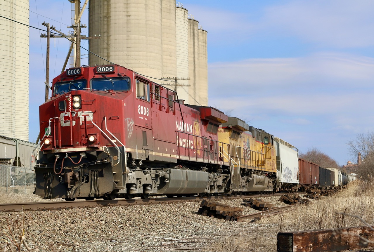 Typically CPKC train 135 travels through the area during the pre dawn hours so it was nice catching it after noon this day. Both CP and UP units are rebuilt AC4400’s with the UP starting life as Southern Pacific 139. The train is seen passing the remnants of removed ADM spur, along with some more recently dumped piles of ties. The Ardent mill is in the background.