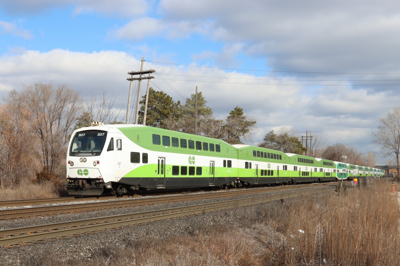 Cab Car GO 307 leads a westbound 12 car GO train as it crosses the demarcation point for the Metrolinx portion and CN portion of the Oakville Subdivision at Mile 32.0, very near the location of the former Burlington (Freeman) station. Next stop Aldershot.