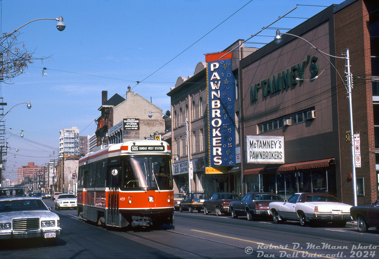 TTC CLRV 4159 is short-turning on a 505 Dundas run, heading southbound on Church Street approaching Queen Street. It's passing "pawn shop alley" along Church, this area long known for its many pawn shops. McTamney's Pawnbrokers and Williams Pawnbrokers are visible here, and Grant's Pawnbrokers and Thifty's occupied multiple storefronts to the south along with various other used buy and sell stores in the immediate area (some still survive here today, including McTamney's).

Robert D. McMann photo, Dan Dell'Unto collection slide.