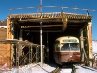 TTC PCC 4480 (A7-class, blt CC&F 1949) pops out from the under-construction Queen Elizabeth Way streetcar tunnel on the private streetcar right-of-way from Humber Loop, about to enter Lake Shore Blvd and head west to Long Branch.<br><br>The wooden shoring and scaffolding around the QEW and streetcar tunnel was due to this section of the QEW near Swansea being under expansion and realignment in 1973-74, with new lanes added to the south of the existing roadway (requiring extending the existing streetcar tunnel under the new lanes). Streetcars to Long Branch were kept running during the construction period, passing through the tunnel via a single track controlled by traffic lights at both ends (more info and photos can be found at Steve Munro's blog post <a href=https://stevemunro.ca/2019/06/30/humber-loop-qew-realignment-1973-74/><b>here</b></a>).<br><br><i>Tom Gascoigne photo, Dan Dell'Unto collection slide.</i>