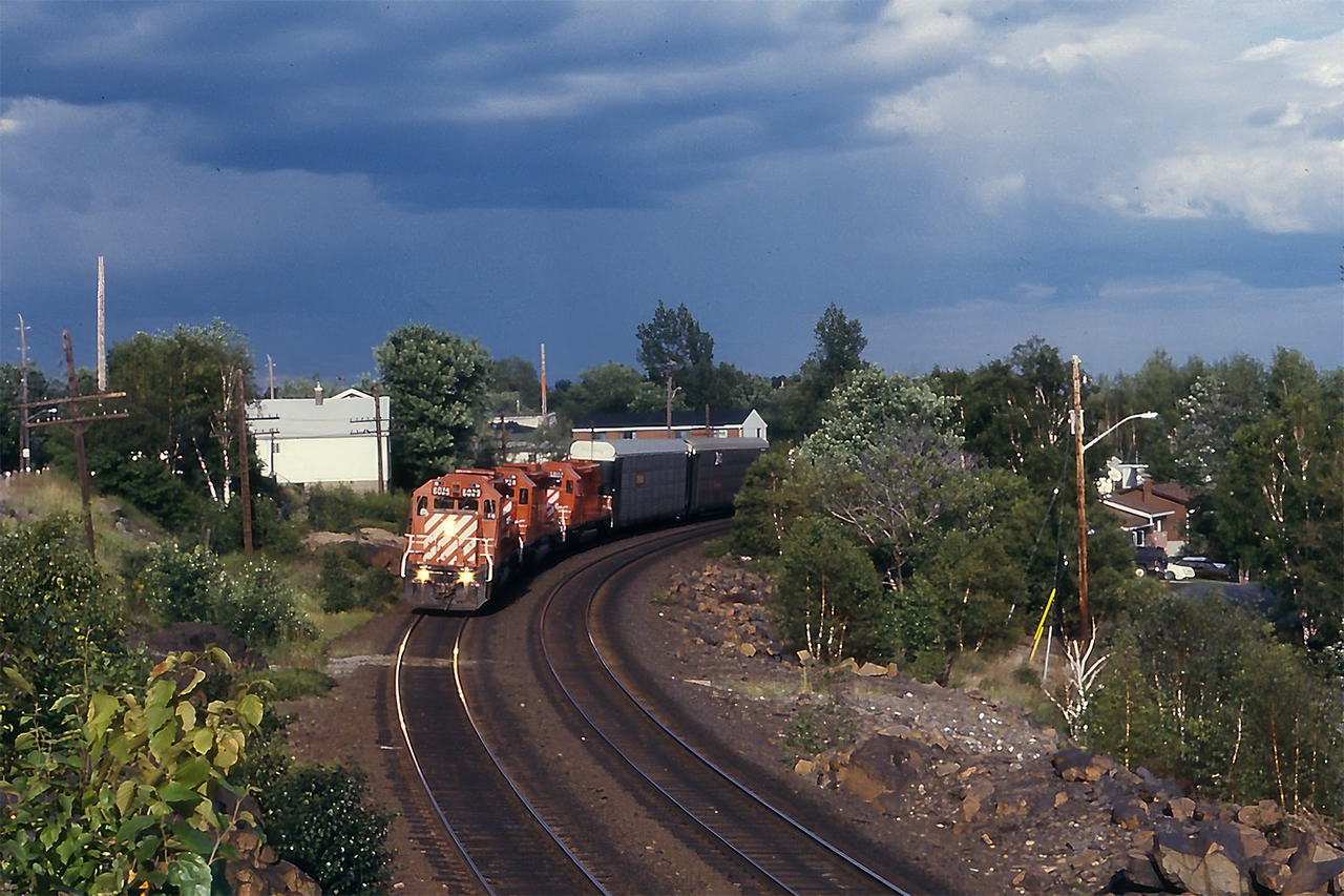 A late afternoon westbound runs through the curves north of Ramsey Lake, approaching Sudbury Station.