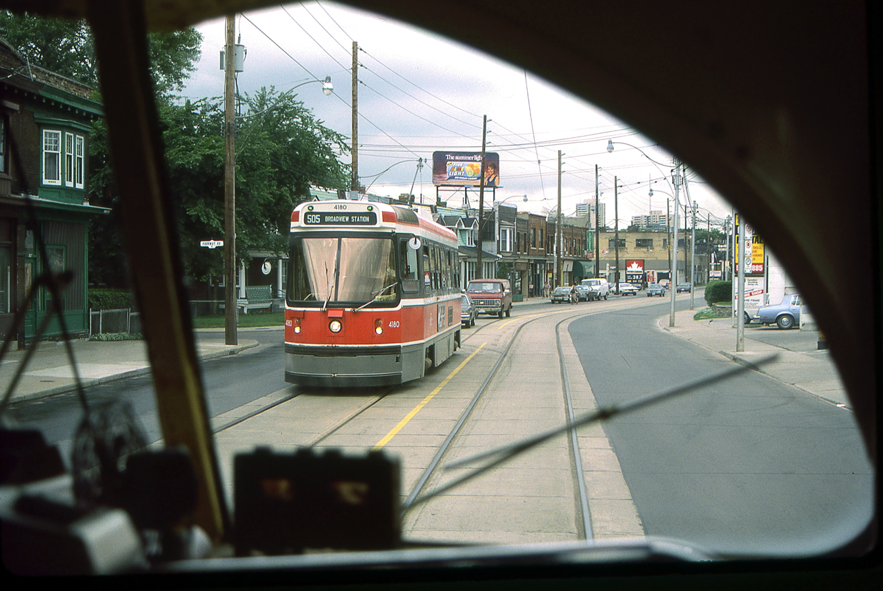 It is an overcast day in Toronto in August 1986. I am in a TTC PCC streetcar which is about to have a meet with TTC 4180.