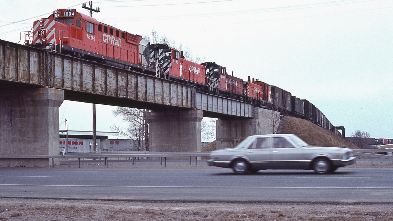 ...the CP Rail Oshawa yard job - servicing the GM yard...in Oshawa


Power: 1980 remanufactured MLW RS-18u #1804 (was #8740) and  GMD 1959 built SW1200RS  #8130 /  8143  / 8157 


Some 8100's rebuilt 1981-1985: #8130 to CP#1275;  #8142  sold to Black River & Western in 1999; #8157  to CP#1243. 


At the 401 / CP Rail overpass, April 19, 1981 Kodachrome by S.Danko


BTW, in the foreground, that's a  Michigan built '76 to '80   Dodge Aspen / Plymouth Volare –  Chrysler's successor to the Dart, Duster, Valiant series. Aspen / Volare could be ordered with a Mopar 360 cubic inch (5.9 Litre,  two barrel carburetor) V-8 with a floor mounted four speed manual transmission, although it seemed that most were built with the 225 cubic inch slant six and a 3 speed automatic.


And at that time the 401 was simple: two lanes each direction.


sdfourty