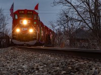 CP's Holiday Train parked over Water St in Cambridge as the show goes on in the background. In about 15 minutes, it will slowly pull out onto the Grand River Bridge, pause briefly and head for the next show in Ayr, 25 minutes don't the tracks. 

And for those "wondering" how I got this shot, I climbed up the riverbank under the bridge, next to the school, and shot this through the fence. 