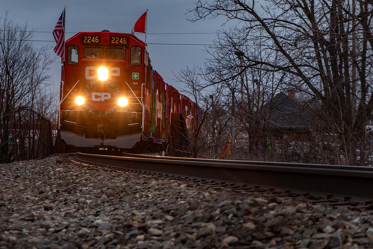 CP's Holiday Train parked over Water St in Cambridge as the show goes on in the background. In about 15 minutes, it will slowly pull out onto the Grand River Bridge, pause briefly and head for the next show in Ayr, 25 minutes don't the tracks. 

And for those "wondering" how I got this shot, I climbed up the riverbank under the bridge, next to the school, and shot this through the fence.