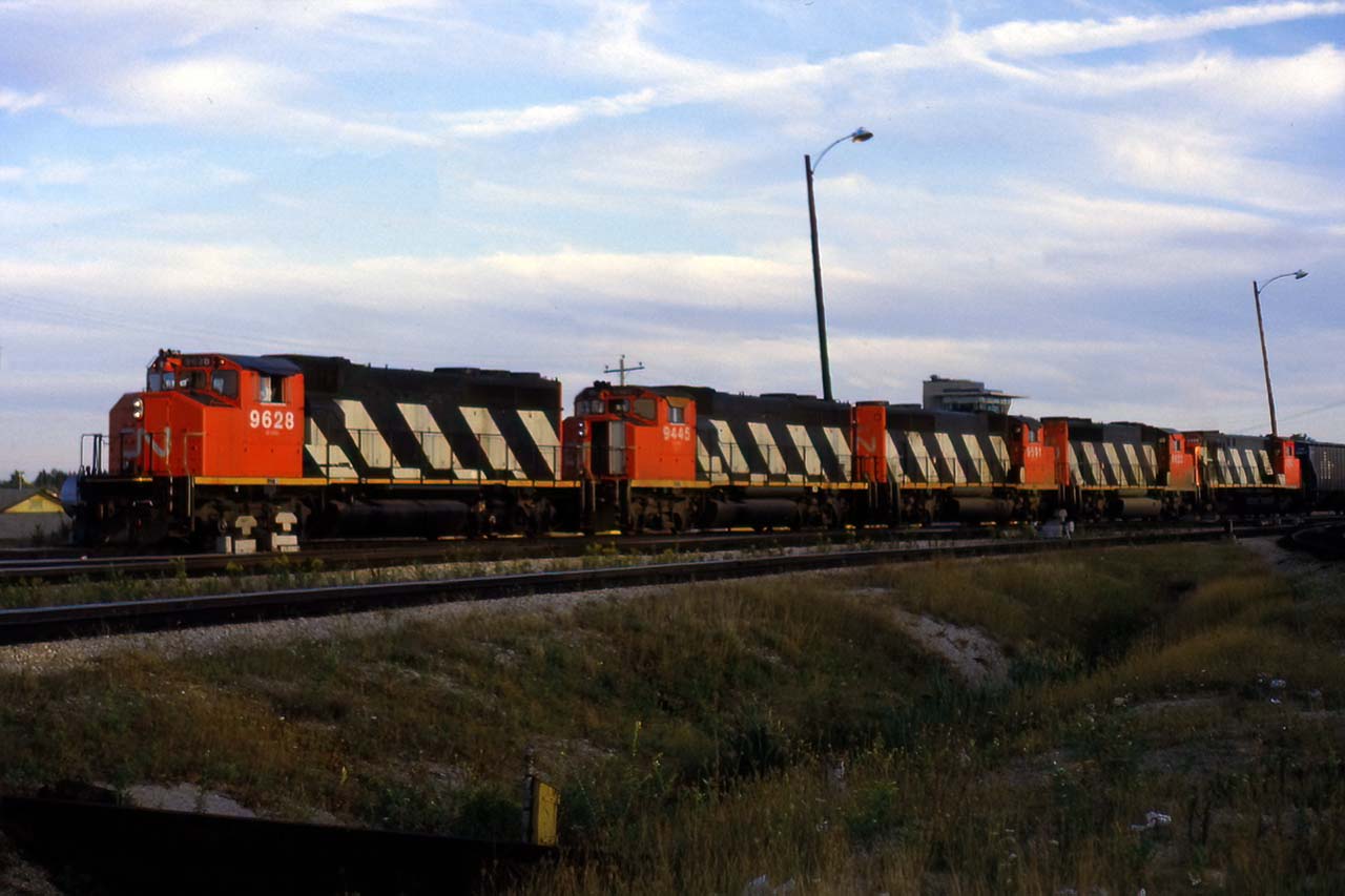 4 GP40-2's and a new HR412 bring an early 393 into Mac Yard. 393 was usually a Toronto bypass, with lots of newsprint from the northeast US and Quebec. It was also a prime user of MLW power, so this was also a little odd....but nice to see,