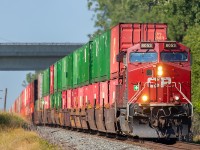 CP 8053 begins down the hill towards the Trent River which it will soon cross as it makes its way east on this sunny morning.