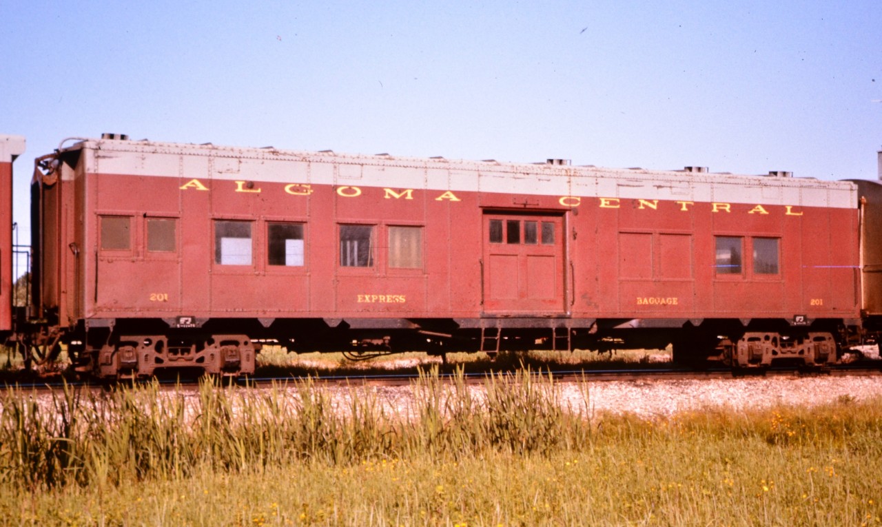 While working on a CN tie gang back in the summer of 1976 I managed to snap this pic of AC 201 that was spliced into an Algoma Central passenger train departing Oba for Hearst, ON. Some interesting trucks under this car.