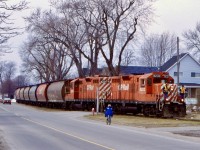 Other than an odd shape patch of grass running parallel to Park street, few today driving along the residential road would probably have no idea a rail line once ran there. This line was once an important interchange between CN and the old Canada Southern as well as part of the CASO’s connection to Queenston and Niagara on the Lake. By this date the line was being used as an interchange point between CN and CP the rest of the line was abandoned many years earlier. When the city of Niagara Falls paid CP to relocate its traffic out of the city, the connection here too was abandoned. This day a pair of CP GP9U’s have a decent cut of grain cars in tow as they head back to home rails and towards Welland. The two crew members are on the front porch looking for motorists not paying attention, as the train approaches Chrysler Ave.