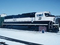 In 1993, Burlington Northern had placed a record setting 350-unit order with GMDD in London, Ontario for 4,000 horsepower SD70MAC’s totalling $675 million. In December 1993, the first one, BN 9400 rolled-off the assembly line at the London plant with 349 more to follow over the course of the next couple years. Painted in the BN “Executive Scheme” the units departed London for delivery to BN in Chicago via both CN and Canadian Pacific. 
<br>
Here BN 9421 gleams in the early morning winter sun at CN’s yard in London waiting to be lifted after having made the short trip from the GMDD plant. 

