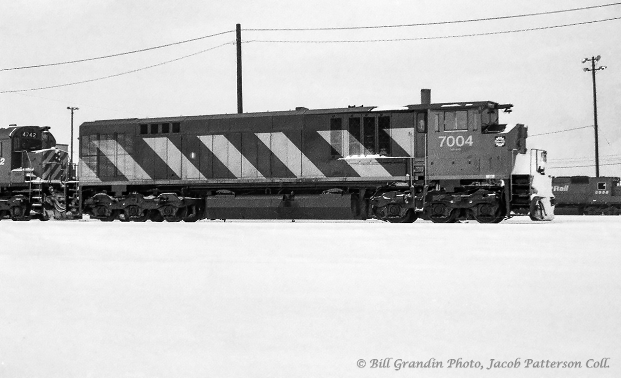 Bombardier HR-616 demonstrator 7004, one of four such units undergoing testing for the CP from February 1983 - May 1984, is seen on a snowy April day at Agincourt Yard.  Trailing behind the unit is CP 4742 and QNSL 209, while CP 5956 can be seen in the distance.  Only twenty of these units were ever built, all for CN, numberd 2100 - 2119.

See more of these units testing on CP:
May 1983, Agincourt
May 1983, North Bay
May 1983, North Bay
May 1983, Sturgeon Falls
July 1983, Galt
February 1984, Agincourt
Winter 1983-1984, London



Bill Grandin Photo, Jacob Patterson Collection Negative.